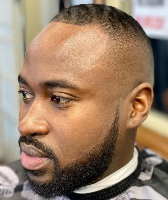 Low fade with a sculpted full beard