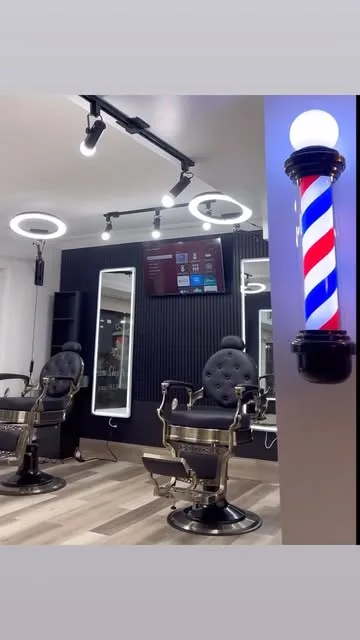 The chairs at Rite Cut under the ring lights, barber pole in the window