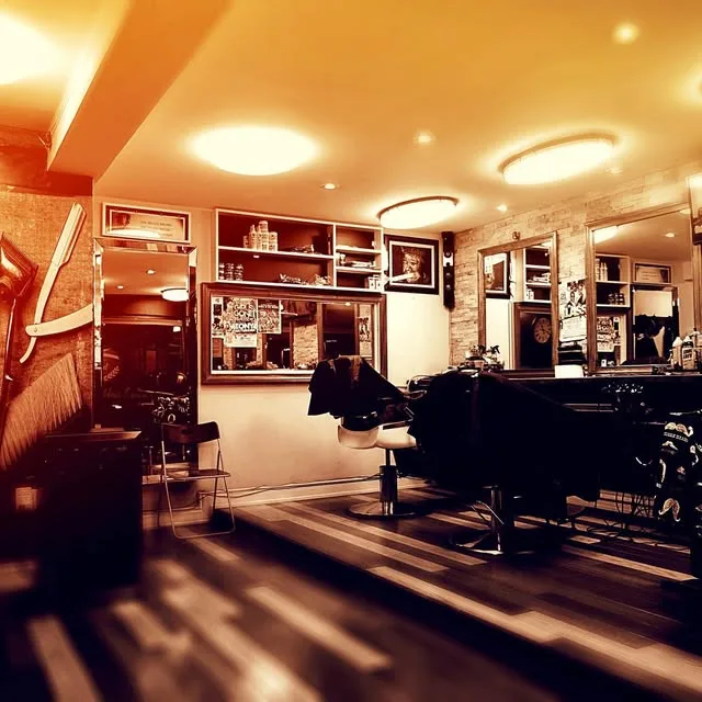 The shop's waiting lounge, warm wood and framed prints
